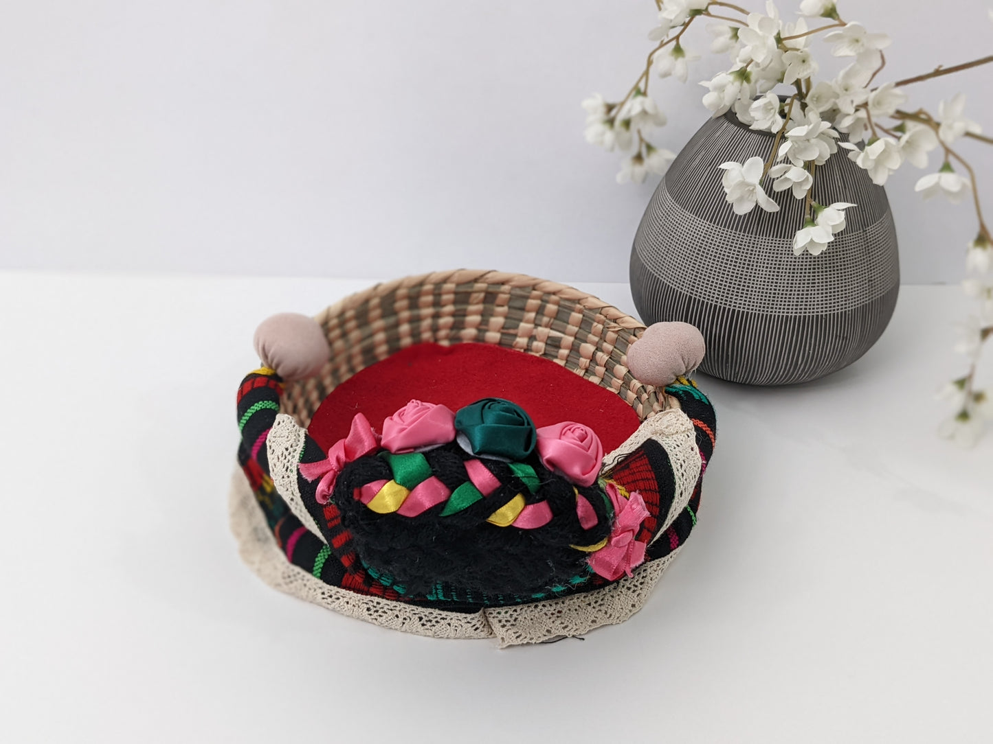 Small Decorative Basket Frida Kahlo by Luna Marie Designs. Our version of Frida Kahlo- Small Palm Basket dressed in black cambaya, tipic Kahlo's hair style adorned with multiple ribbon colors and multicolor roses. Frida 0003 Back