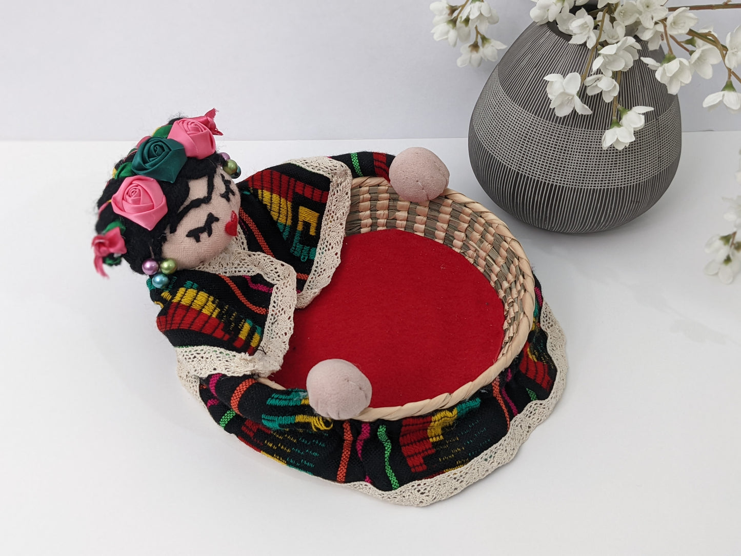 Small Decorative Basket Frida Kahlo by Luna Marie Designs. Our version of Frida Kahlo- Small Palm Basket dressed in black cambaya, tipic Kahlo's hair style adorned with multiple ribbon colors and multicolor roses. Frida 0003 Side b